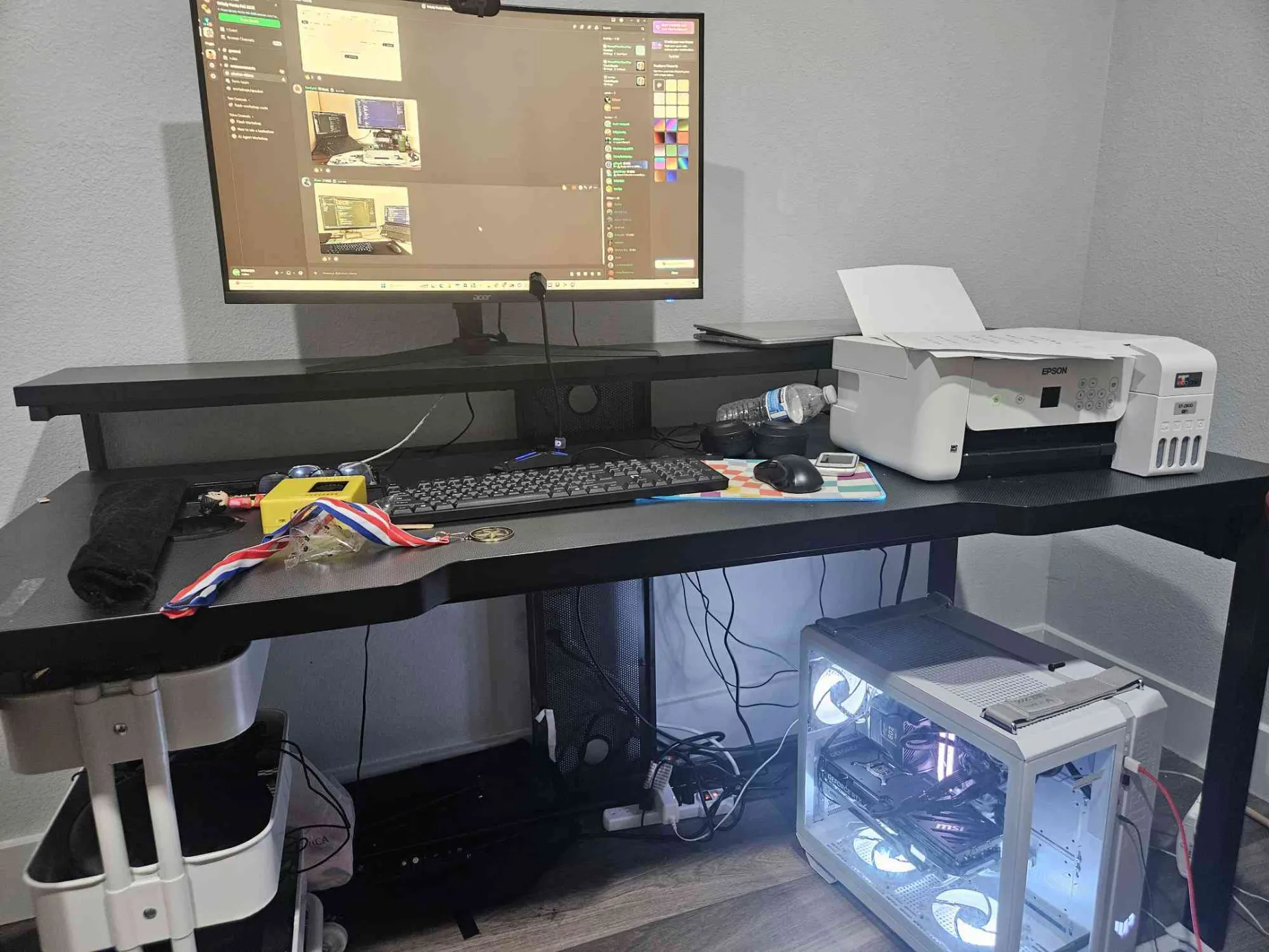 Full desk setup at Grizzly Hacks Fall 2025 with PC and awards